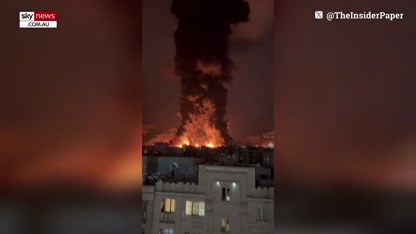 Black rain falls as Iran's night sky lights up following devastating strikes on oil depots